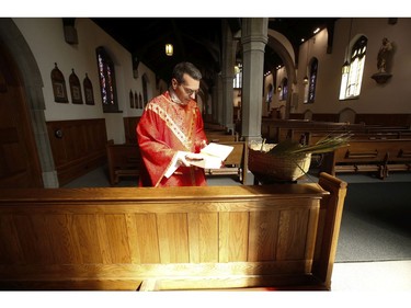 Father Peter Turrone performs Palm Sunday mass and blesses the palms with holy water at the Newman Centre Catholic chapel on St. George St. before an empty church. It is a the beginning of Holy Week leading up to Good Friday and Easter next Sunday on Sunday April 5, 2020. Jack Boland/Toronto Sun/Postmedia Network
