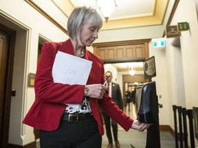 Minister of Health Patty Hadju uses hand sanitizer before entering the room for a press conference on COVID-19 in West Block on Parliament Hill in Ottawa, on Thursday, March 19, 2020. (THE CANADIAN PRESS/Justin Tang)