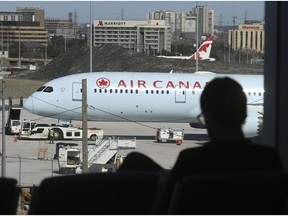 Air Canada planes are parked off in a corner of the tarmac outside of Terminal 3 on Thursday April 2, 2020.