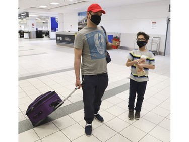 Ken Abbasi, and his 10-year old son Ibrahim of Edmonton flew 14 hours from Lahore Pakistan with help from the Canadian High Commission to Toronto. The flight cost $7,600 and he had to borrow money to get home. He will now go to into quarantine for 14 days at his Edmonton home while his wife and other child with stay with his brother  Thursday April 2, 2020. Jack Boland/Toronto Sun/Postmedia Network