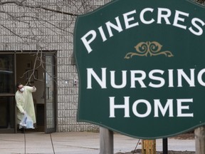 A staff member from the Pinecrest Nursing Home in Bobcaygeon thanks a community member for delivering needed supplies during a deadly Covid-19 outbreak on Monday, March 30, 2020. (Stan Behal/Toronto Sun/Postmedia Network)