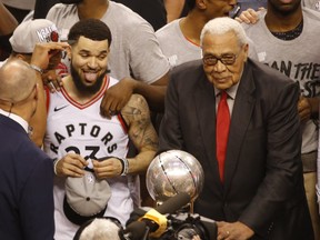 Raptors’ Fred VanVleet (23) is excited as he spies the Larry O’Brien trophy with Wayne Embry last summer.