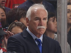 Florida Panthers head coach Joel Quenneville stands behind his team's bench.