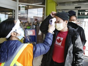 Customers entering the T&T Supermarket on Warden Ave. north of Steeles Ave. in Markham get a temperature scan to check for precautionary signs of COVID-19 on Monday, April 20, 2020. (JACK BOLAND/TORONTO SUN)