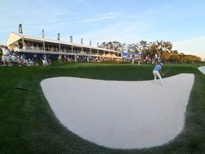 Tony Finau hits out of the sand on to the 18th green during the first round of The Players Championship at TPC Sawgrass, in Ponte Vedra Beach, Fla., on March 12, 2020.