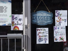 The storefront window of a closed business on Danforth Ave. in Toronto on April 2, 2020.