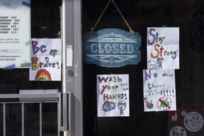 The storefront window of a closed business on Danforth Ave. in Toronto on April 2, 2020. Stan Behal/Toronto Sun