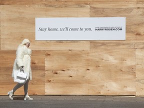 Businesses on the fashionable Bloor Street in downtown Toronto boarded up on Thursday,  April 9.