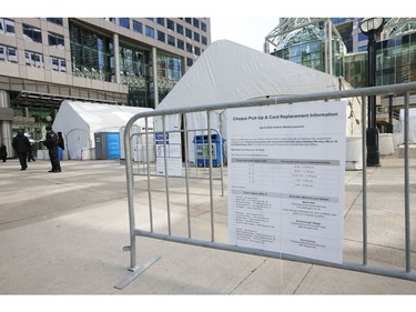 Two massive tents with tables and chairs inside are set up at Metro Hall's David Pecaut Square. Adminstrators said they are set up to deliver cheques and cards through the Ontario Works Program in Wednesday April 1, 2020. Jack Boland/Toronto Sun/Postmedia Network