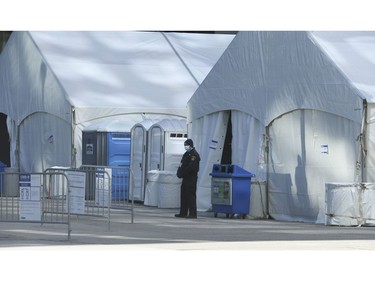 Two massive tents with tables and chairs inside are set up at Metro Hall's David Pecaut Square. Adminstrators said they are set up to deliver cheques and cards through the Ontario Works Program in Wednesday April 1, 2020. Jack Boland/Toronto Sun/Postmedia Network