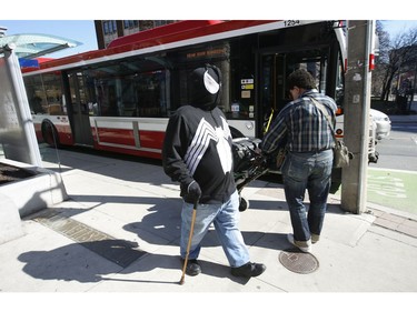 A man dressed up as the Marvel comic book character Venom is totally masked up as he strolls along Wellesely St. at Jarvis St.   in Wednesday April 1, 2020. Jack Boland/Toronto Sun/Postmedia Network