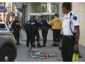 Toronto Police arrest a man who allegedly keyed a car during an argument and then took on police during the ensuing apprehension outside the Eaton Centre on Wednesday April 1, 2020. Jack Boland/Toronto Sun/Postmedia Network
