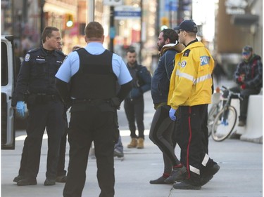 Toronto Police arrest a man who first keyed a car during an argument and then took on police during the ensuing apprehension. He was arrested outside the Eaton Centre at Yonge St. and Dundas Ave. W.   in Wednesday April 1, 2020. Jack Boland/Toronto Sun/Postmedia Network