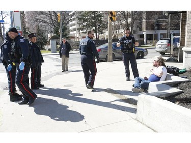 A vagrant who is allegedly drunk and somewhat metal unstable was calmed down , but finally taken into custody by Toronto Polic officers at Wellesley St. and Jarvis St.   in Wednesday April 1, 2020. Jack Boland/Toronto Sun/Postmedia Network
