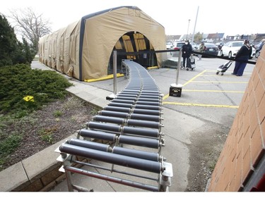 Toronto Daily Bread Food Bank on New Toronto St. in Etobicoke has set up an inflatable medical tent outside its facility along with a conveyor belt to get food to its clients since they cannot come in the building  on Wednesday April 8, 2020. Jack Boland/Toronto Sun/Postmedia Network