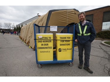 Neil Hetherington CEO of the Toronto Daily Bread Food Bank poses outside their location on  New Toronto St. in Etobicoke. The TDBFB has set up an inflatable medical tent outside its facility along with a conveyor belt to get food to its clients since they cannot come in the building  on Wednesday April 8, 2020. Jack Boland/Toronto Sun/Postmedia Network
