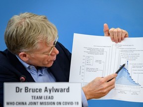 In this file photo taken on February 25, 2020, Bruce Aylward shows graphics during a press conference at the WHO headquarters in Geneva. (FABRICE COFFRINI/AFP via Getty Images)