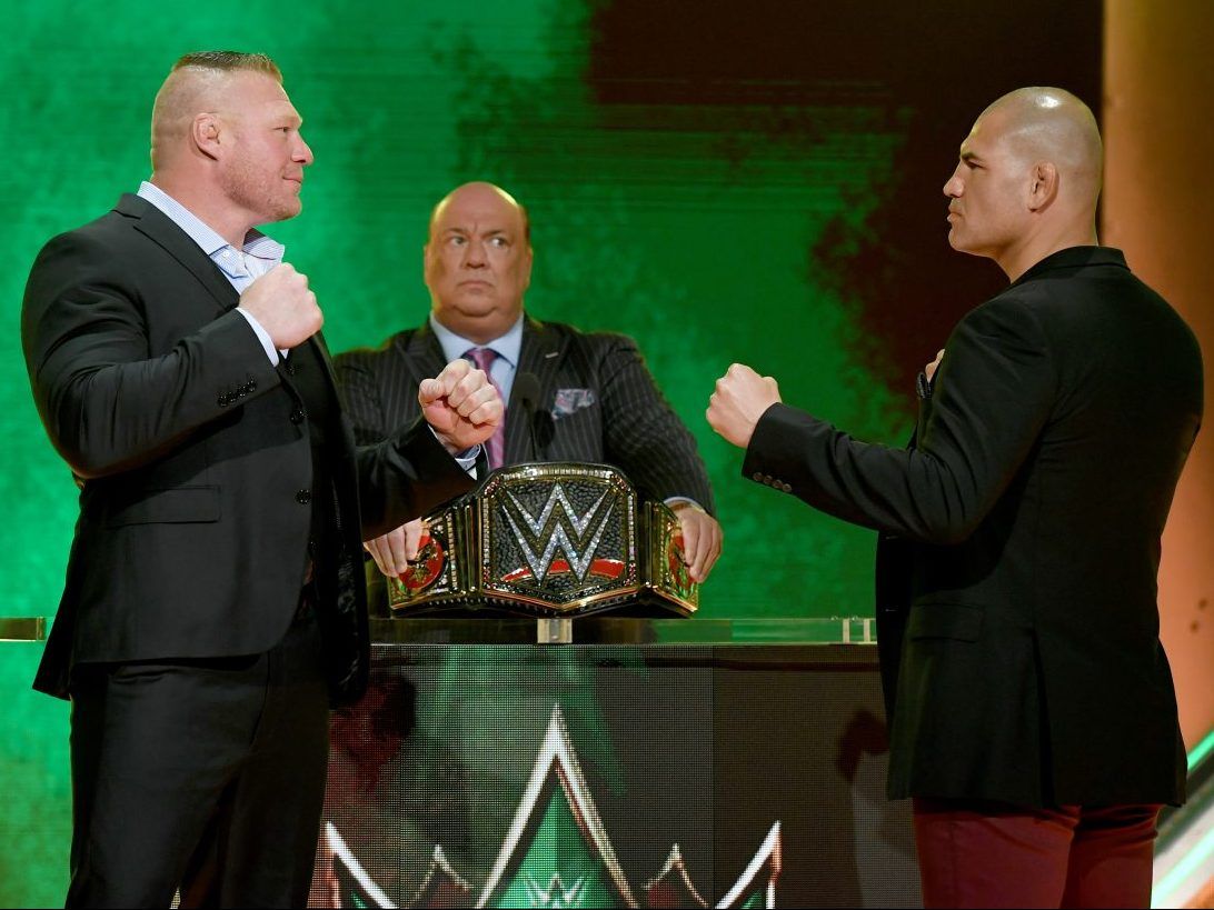 WWE champion Brock Lesnar (left) and former UFC heavyweight champion Cain Velasquez face off as Lesnar’s advocate Paul Heyman looks on at T-Mobile Arena on October 11, 2019 in Las Vegas.