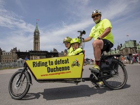 Andrew Sedmihradsky arrives at Parliament Hill with children, Max and Isla, to complete their ride from Hamilton for the 4th Max's Big Ride to help defeat Duchenne muscular dystrophy Sunday, June 17 2018.
