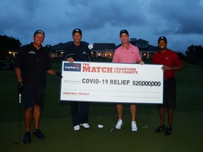 Tiger Woods and former NFL player Peyton Manning celebrate defeating Phil Mickelson and NFL player Tom Brady of the Tampa Bay Buccaneers on the 18th green during The Match: Champions For Charity at Medalist Golf Club on May 24, 2020 in Hobe Sound, Florida.