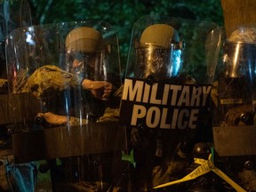 Military Police stand in riot gear as they block protesters across from the White House on May 30, 2020 in Washington DC, during a protest over the death of George Floyd.