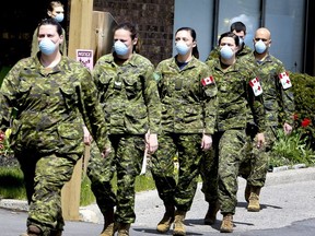 Members of the Canadian Armed Forces in front of Pickering's Orchard Villa long-term care home on May 6, 2020.
