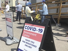People line up for COVID-19 testing in Toronto on May 25, 2020.