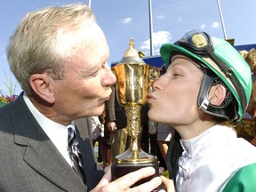 Trainer Ian Black (left) and Jockey Emma-Jayne Wilson kiss the Queen's Plate trophy after winning the race in 2007.