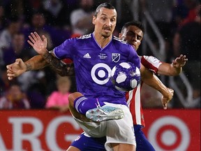 MLS forward Zlatan Ibrahimovic controls the ball in front of Atletico Madrid defender Carlos Isaac during the 2019 MLS all-star game.