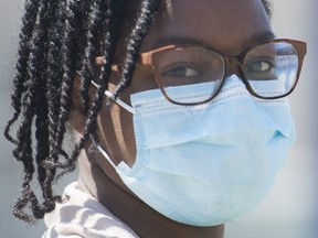 A woman wears a mask in Montreal North, Saturday, May 2, 2020, as the COVID-19 pandemic continues in Canada and around the world.