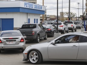 People line up to get food from Peters’ Drive-In in Edmonton on Monday, May 11, 2020.