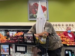 A man wears a Ku Klux Klan hood in a San Diego county city supermarket on May 2, 2020.