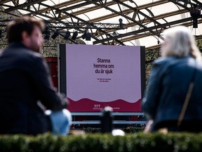 An advertisement of the Swedish healthcare services instructs people to stay home if they are sick, on May 8, 2020 in Stockholm, Sweden.