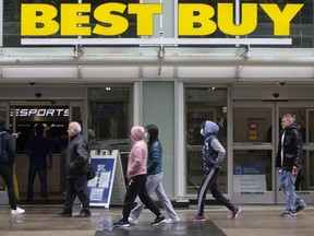 Toronto shoppers walk to and from the Best Buy on Dundas Street West and Bay Street as the Ontario government starts to relax the mandatory closing of businesses in Ontario oon Monday May 11, 2020.