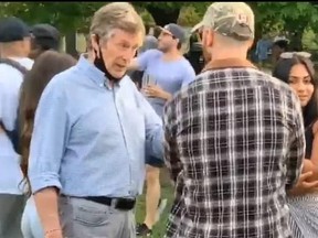 Social media image of Toronto Mayor John Tory at Trinity Bellwoods Park on Saturday, standing less than six feet from others and wearing his facemask around his neck — an act Toronto top doctor Eileen de Villa specifically advised against earlier this week. Tory has since apologized.