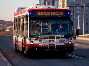 A TTC bus driver wears a mask while driving along Don Mills Rd.  in Toronto, Ont., on April 6, 2020.