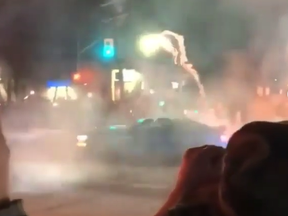 A car is seen shooting fireworks while doing "donuts" in the intersection of Dixon Rd. and Carlingview Dr. in Etobicoke just after midnight Sunday, police said.