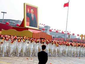 A float carrying a portrait of Chinese President Xi Jinping moves through Tiananmen Square during the parade marking the 70th founding anniversary of People's Republic of China, on its National Day in Beijing, Oct. 1, 2019.