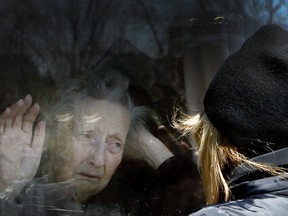 COVID-19-Diane Colangelo visits her 86-year-old mother Patricia through a window at the Orchard Villa long-term care home in Pickering on Wednesday April 22, 2020. Both daughter and mother were in tears.