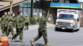 Members of the Canadian Armed Forces stand in front of the Orchard Villa long-term care facility in Pickering on May 6, 2020. 