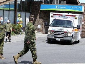 Members of the Canadian Armed Forces in front of Pickering's Orchard Villa long-term care home on May 6, 2020.