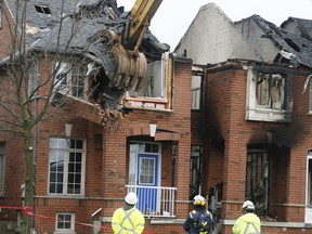 Crews tear down the remains of a Bur Oak Ave. townhome in Markham rocked by an explosion Monday May 18, 2020.