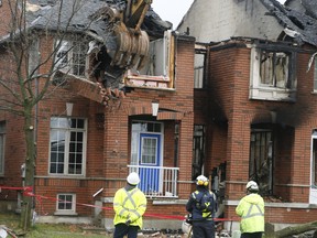 Crews tear down the remains of a Bur Oak Ave. townhome in Markham rocked by an explosion Monday May 18, 2020.