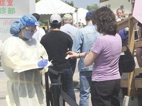 People await COVID-19 testing in Toronto on Monday, May 25, 2020.