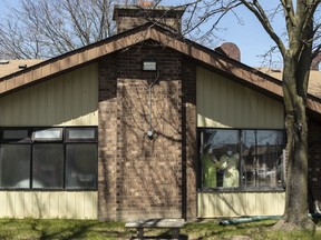 Staff members stand at a window as they watch a parade of well wishers as they drive through Orchard Villa Care home, in Pickering, Ont. on Saturday, April 25, 2020. Experts say the path to fixing long-term care in Canada after the pandemic is not clear, but all agree it starts with improving work conditions for carers.