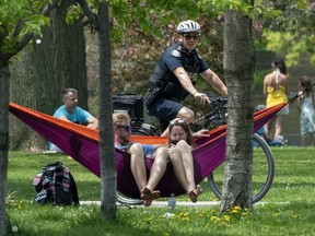 A bicycle police officer patrols Trinity Bellwoods Park in Toronto on Sunday, May 24, 2020.