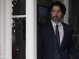 Prime Minister Justin Trudeau looks towards the podium as he walks out the front door of Rideau Cottage to attend a news conference in Ottawa, Monday, May 25, 2020.