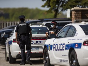 Peel Regional Police at the scene of a suspicious death at an apartment building on Glenn Hawthorne Blvd. in Mississauga, Ont. on Saturday, May 23, 2020.