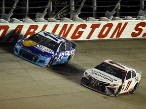 Denny Hamlin, driver of the #11 FedEx Delivering Strength Toyota, leads Ty Dillon, driver of the #13 GEICO Chevrolet, during the NASCAR Cup Series Toyota 500 at Darlington Raceway on May 20, 2020 in Darlington, South Carolina.