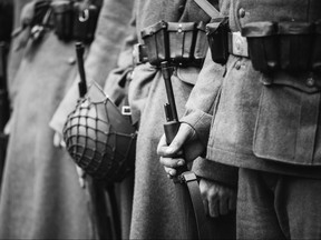 Re-enactors Dressed As World War II German Wehrmacht, Soldiers Standing Order With Rifle Weapons In Hands. Photo In Black And White Colors. Soldiers Holding Weapon Rifles